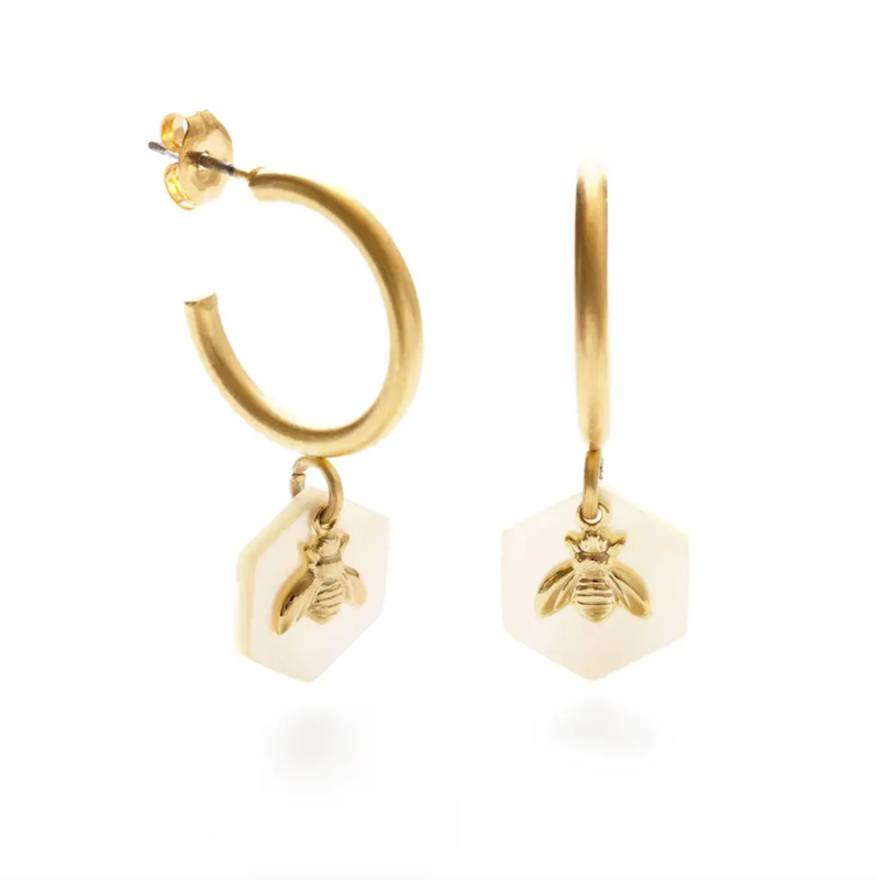 gold huggie earrings with tiny bee on white hexagon